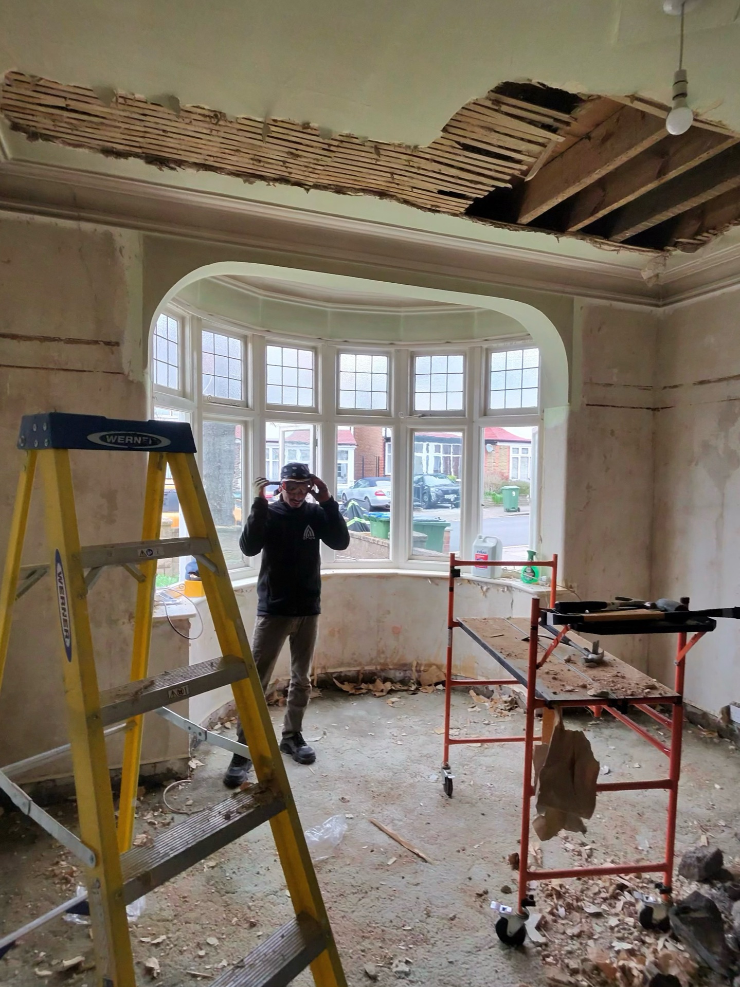 Arya operative pulling down ceiling – joists revealed